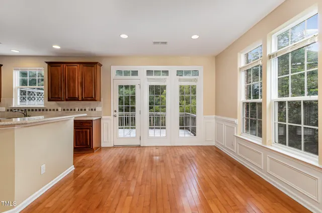 a view of a kitchen with granite countertop a stove top oven a sink and a large window