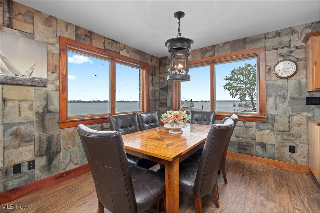 731 Cedar Point Road Sandusky, OH 44870 - Photo 8 of 50 Dining space featuring wood finished floors and a water view
