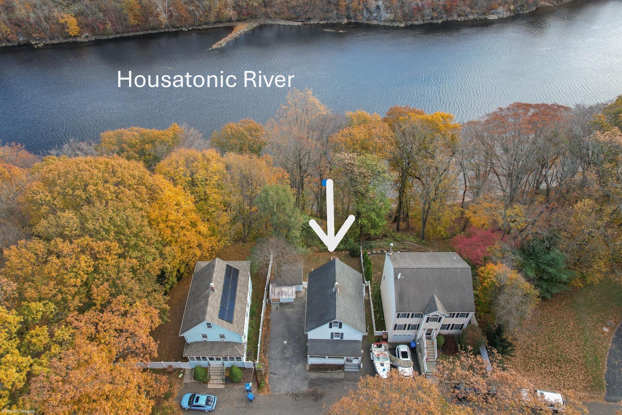 a front view of a house with a yard and parking spaces