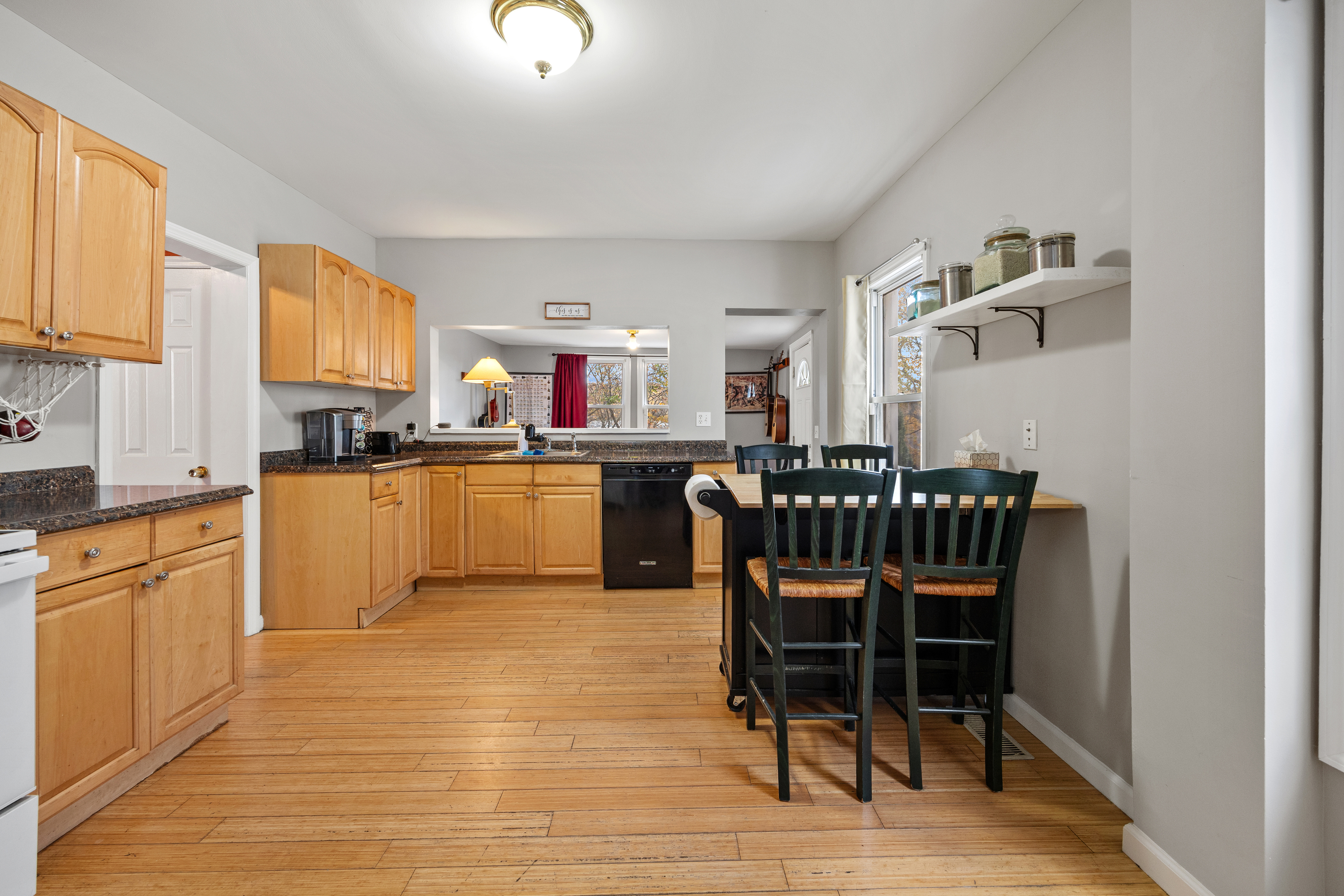 11 Mt Pleasant Street Shelton, CT 06484 - Photo 8 of 23 a kitchen with stainless steel appliances kitchen island granite countertop a dining table chairs and a refrigerator