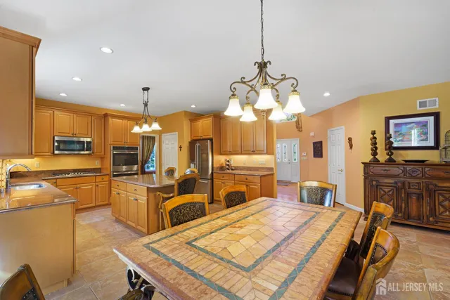 a large kitchen with a table and chairs