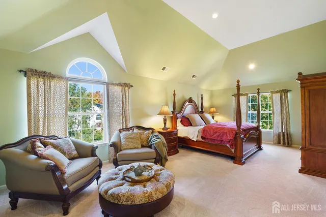 a bed room with couch and a window