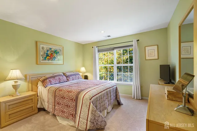 a bedroom with a bed and a desk