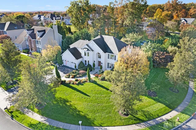 an aerial view of a house with a garden and trees