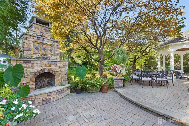 a view of a patio with couches table and chairs and potted plants
