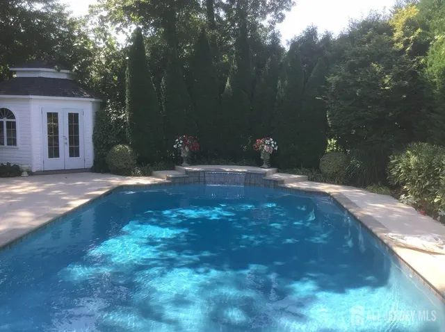 a backyard of a house with table and chairs