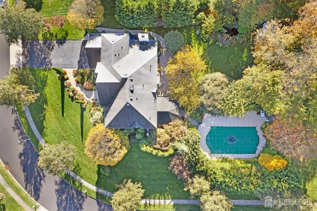 an aerial view of a house with a yard and garden