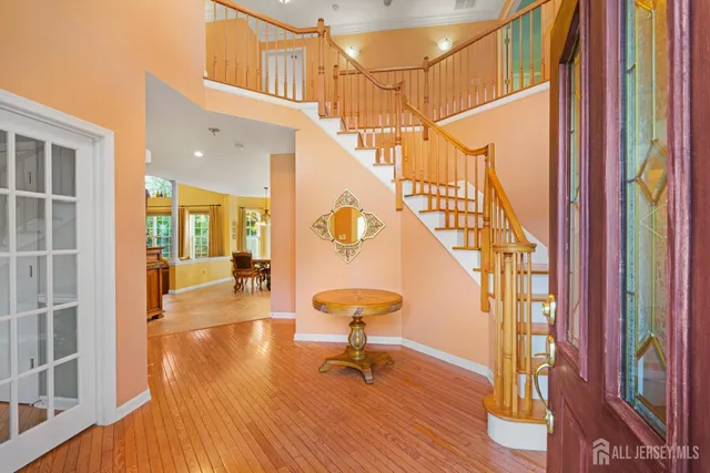 a view of entryway and hall with wooden floor
