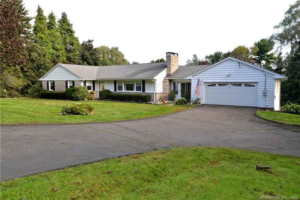 69 Clapboard Ridge Road Danbury, CT 06811 - Photo 1 of 1 a front view of a house with a garden and trees
