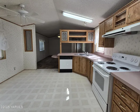 a kitchen with stainless steel appliances granite countertop a stove and a sink