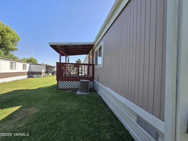 a view of a porch with furniture and garden
