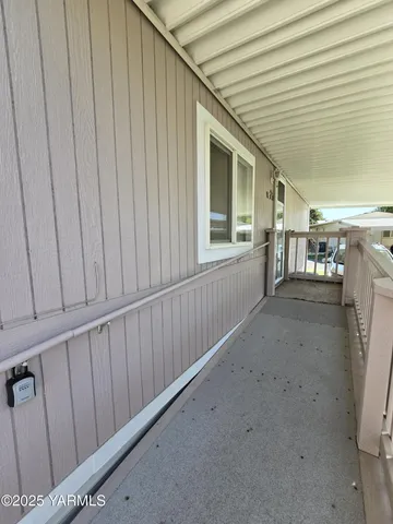 a view of a house with a wooden wall