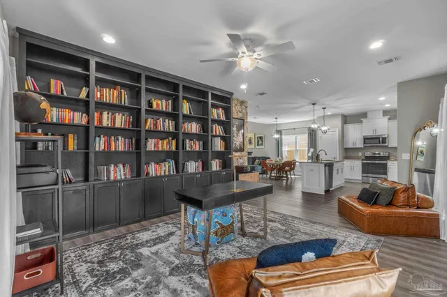 a living room with furniture and a book shelf
