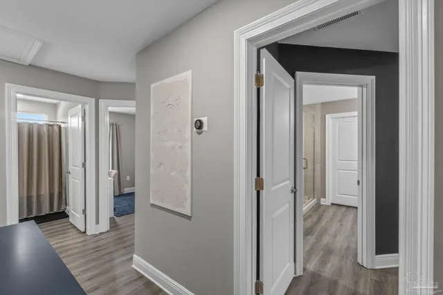 a view of a hallway with wooden floor