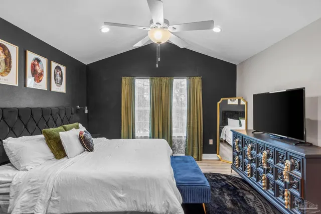 a bedroom with a bed and a flat screen tv