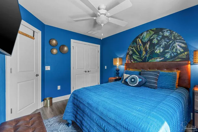 a bedroom with a bed and a painting on the wall