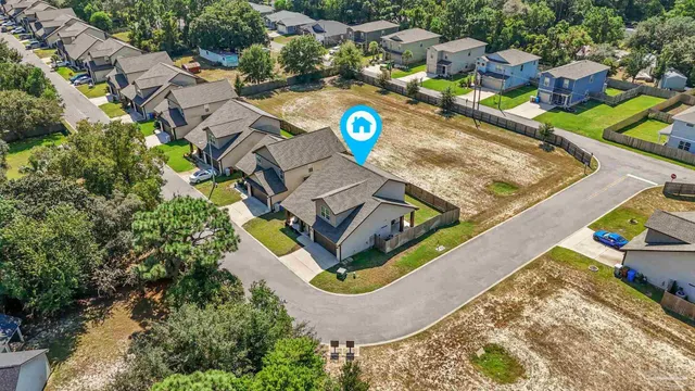 an aerial view of a house with a swimming pool