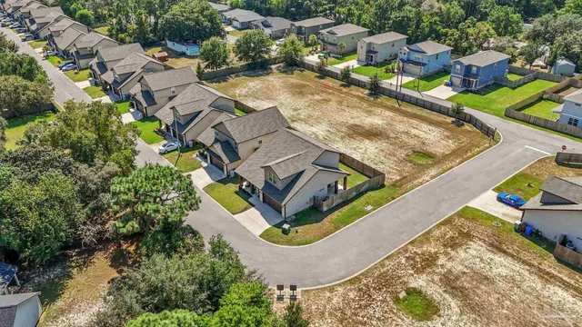 an aerial view of a house with a swimming pool and outdoor space