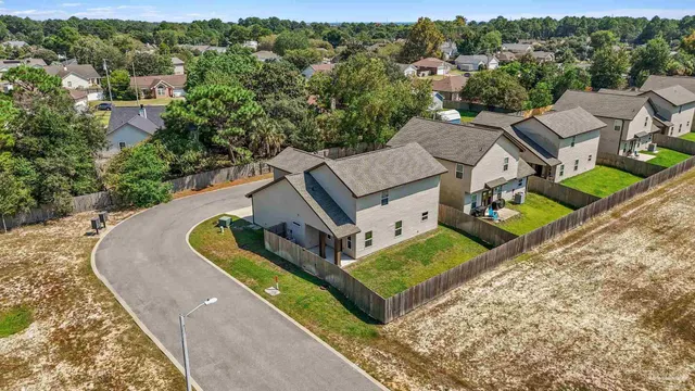 an aerial view of a house with a garden and lake view