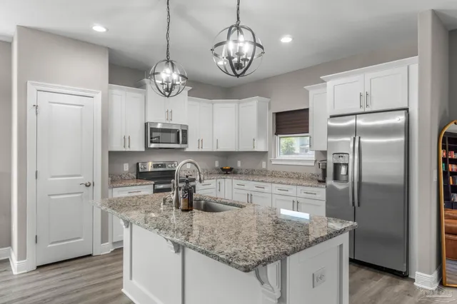 a kitchen with a center island and stainless steel appliances