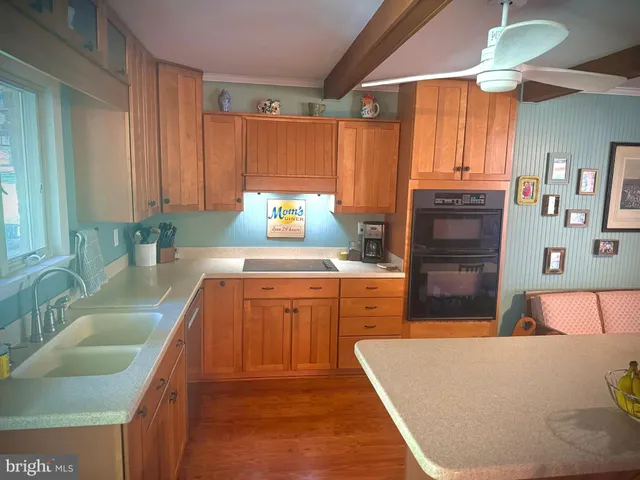 a kitchen with stainless steel appliances granite countertop a sink dishwasher stove and refrigerator