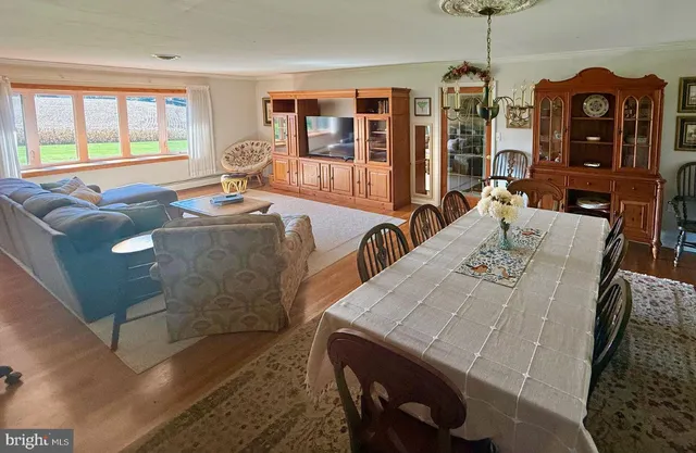 a living room with furniture a chandelier and a flat screen tv