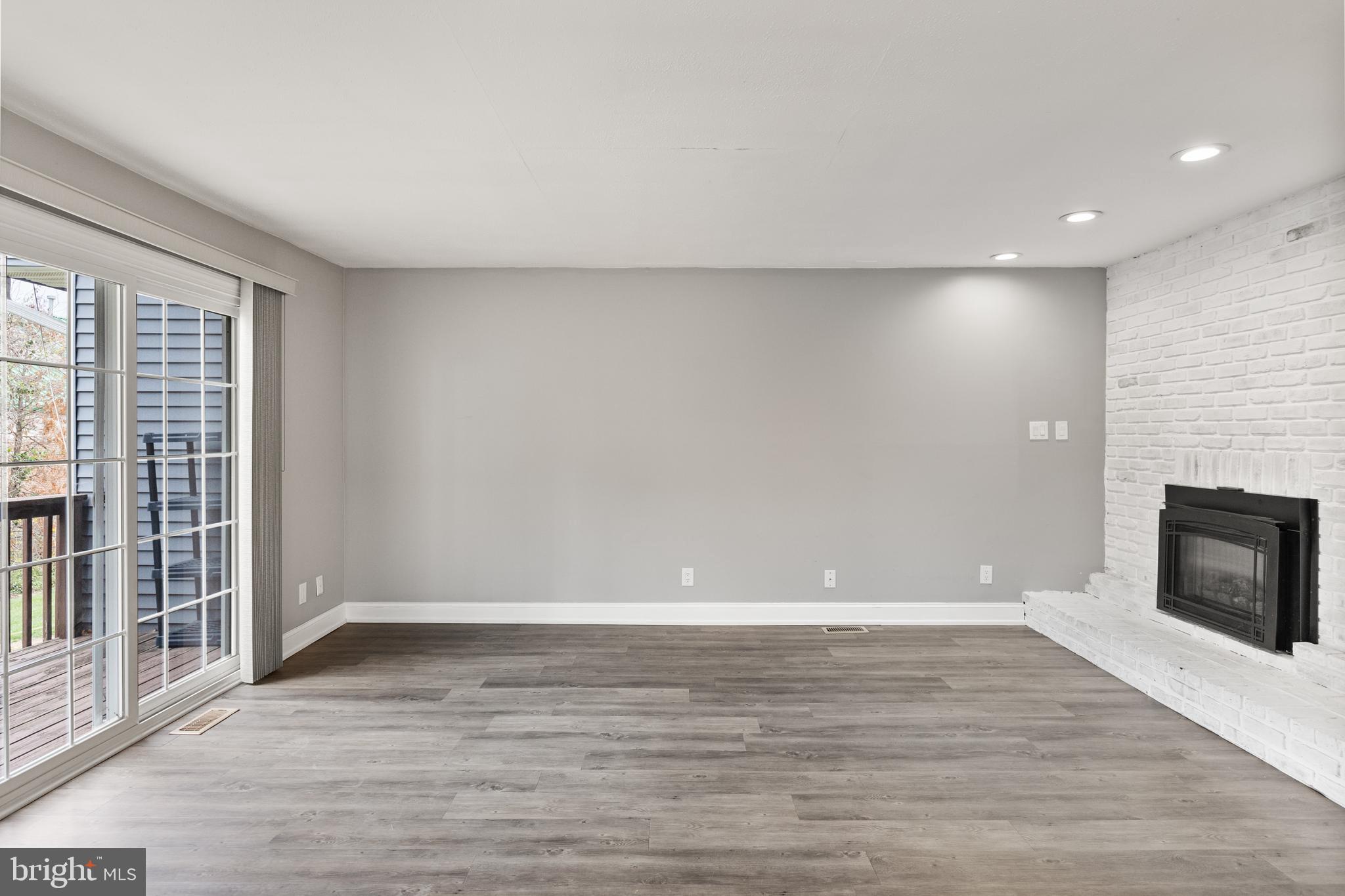 118 Suburban Boulevard Delran, NJ 08075 - Photo 14 of 36 an empty room with wooden floor and fireplace