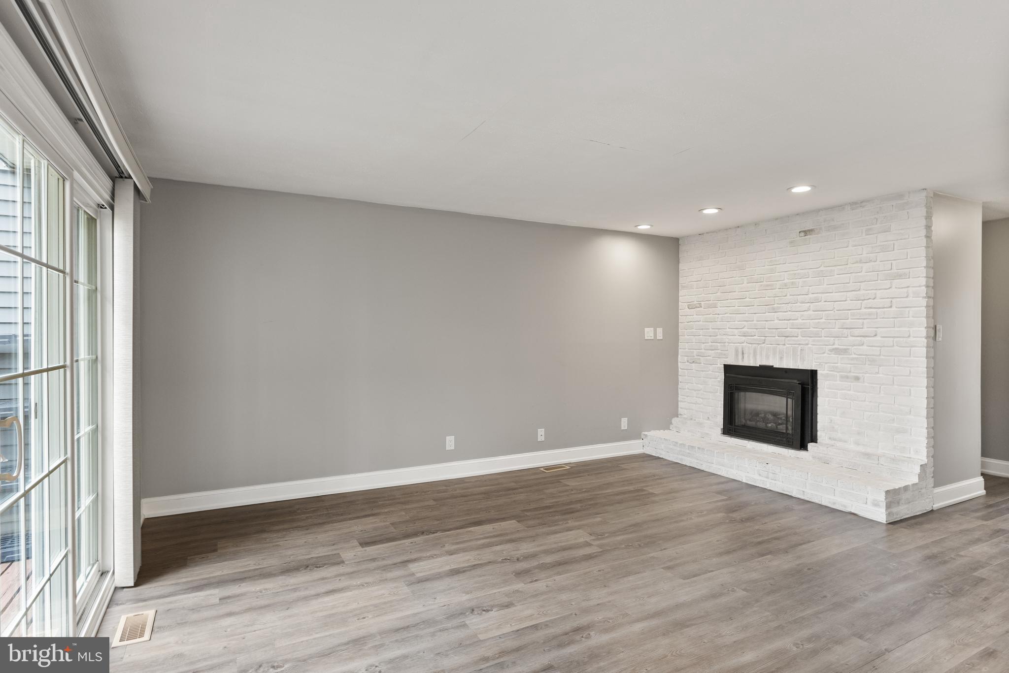 118 Suburban Boulevard Delran, NJ 08075 - Photo 15 of 36 an empty room with wooden floor and fireplace
