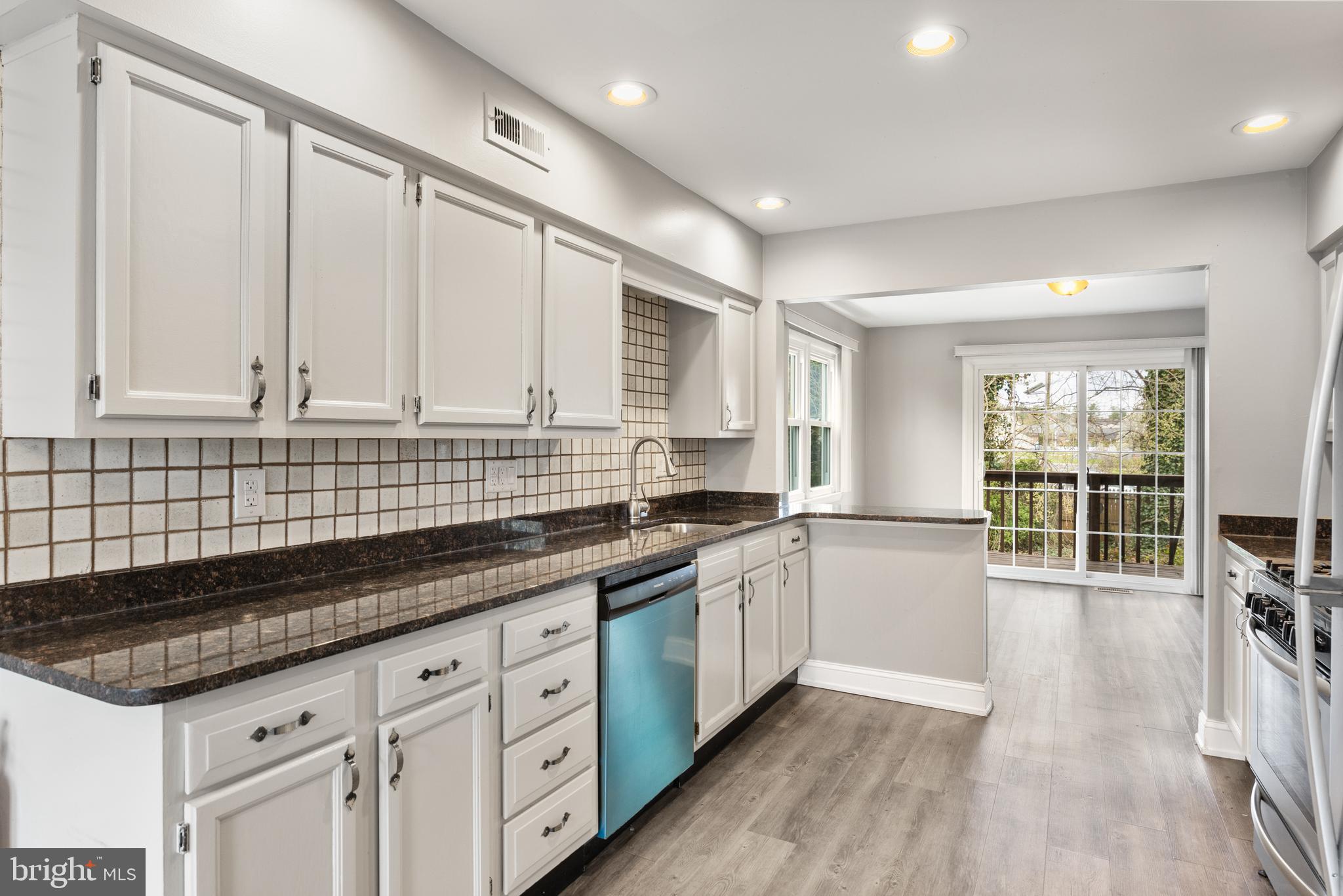 118 Suburban Boulevard Delran, NJ 08075 - Photo 7 of 36 a kitchen with granite countertop a sink a stove and cabinets
