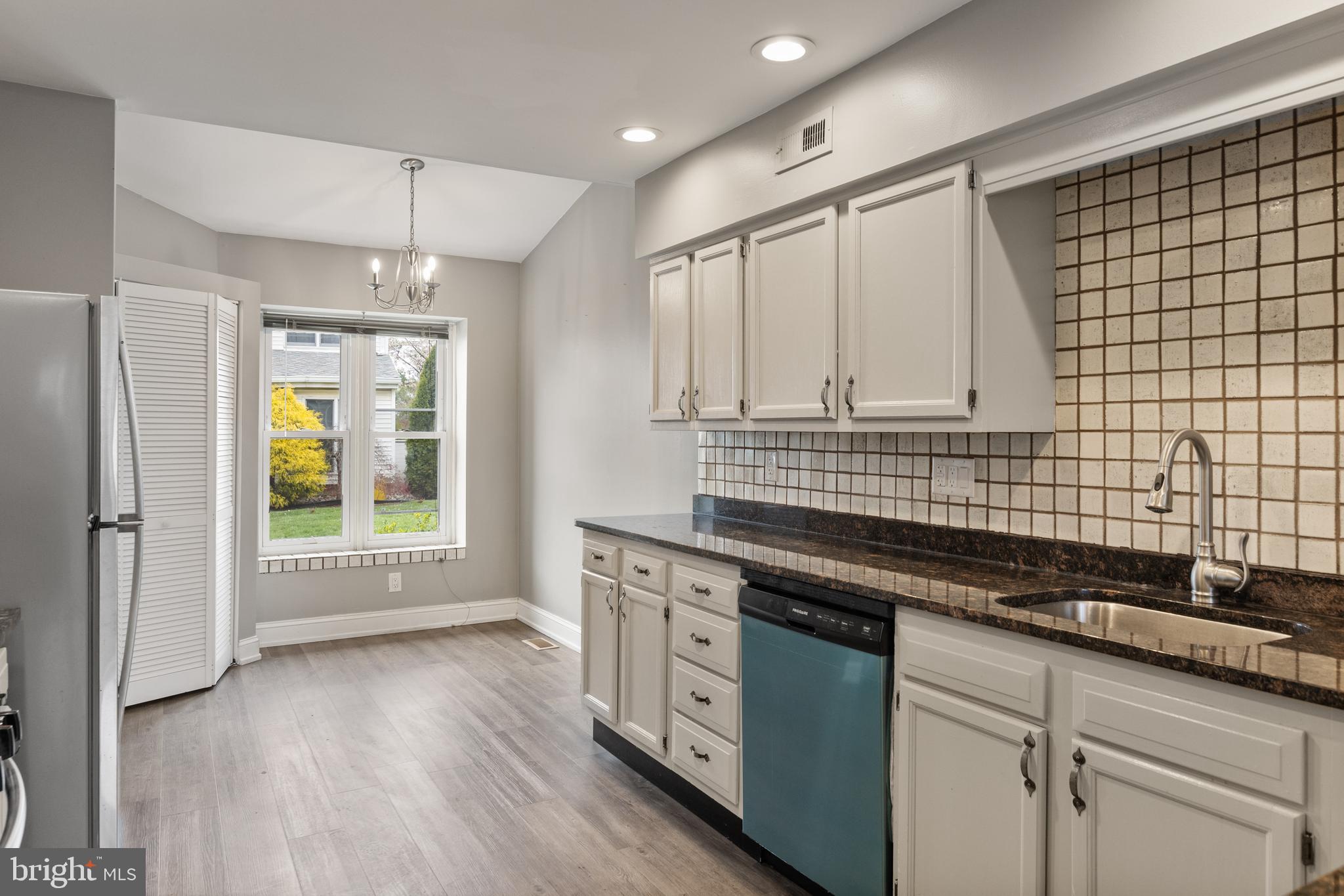 118 Suburban Boulevard Delran, NJ 08075 - Photo 9 of 36 a kitchen with stainless steel appliances granite countertop a stove a sink and white cabinets