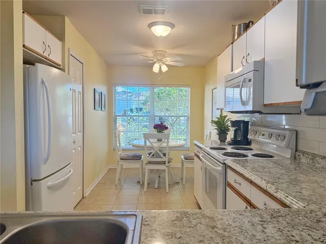 a bedroom with a large bed a chandelier and closet