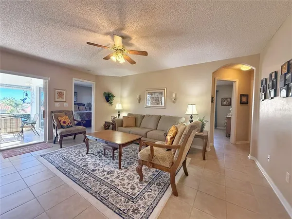 a living room with furniture a dining table and a piano table