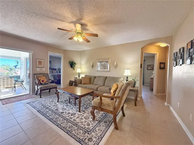 a living room with furniture a dining table and a piano table