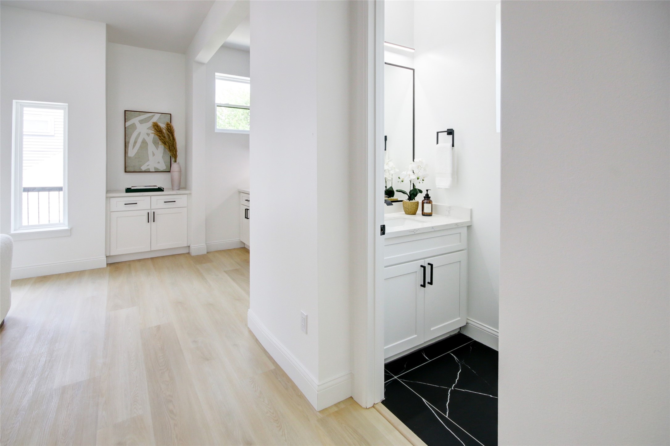 1214 West 24th Street, Unit D Houston, TX 77008 - Photo 25 of 45 a hallway with cabinets and wooden floor