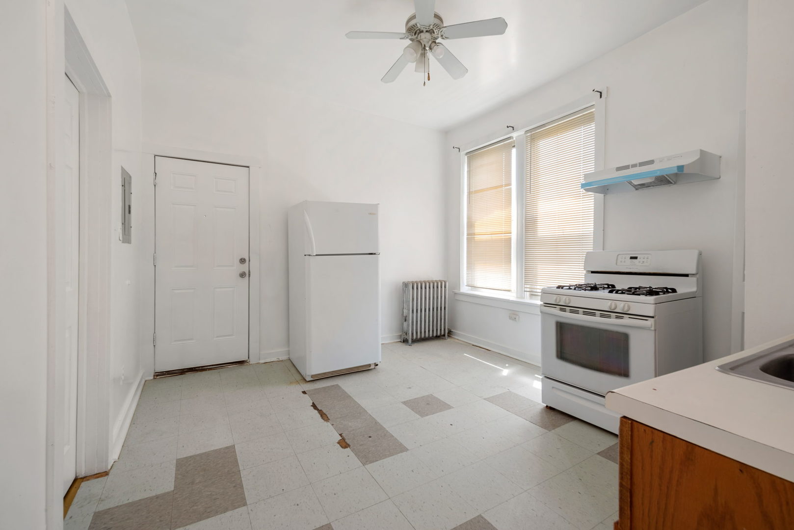 1455 South Avers Avenue Chicago, IL 60623 - Photo 15 of 22 a kitchen with a refrigerator and white cabinets