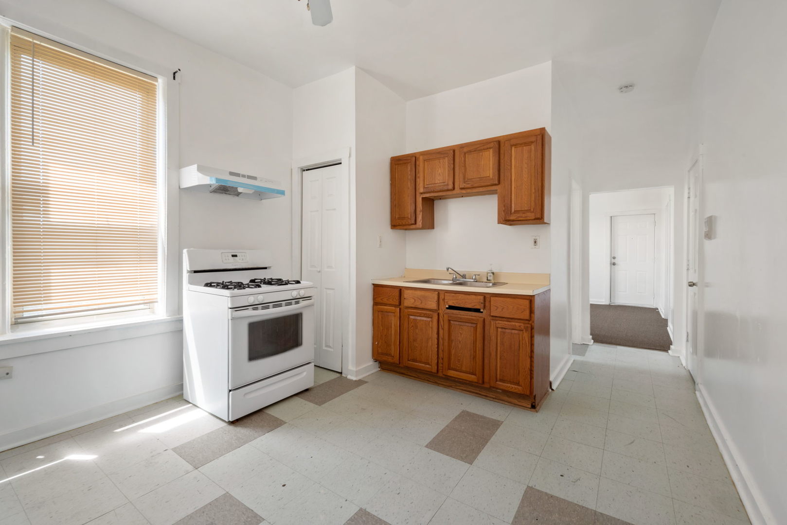 1455 South Avers Avenue Chicago, IL 60623 - Photo 16 of 22 a kitchen with a stove a sink and a refrigerator