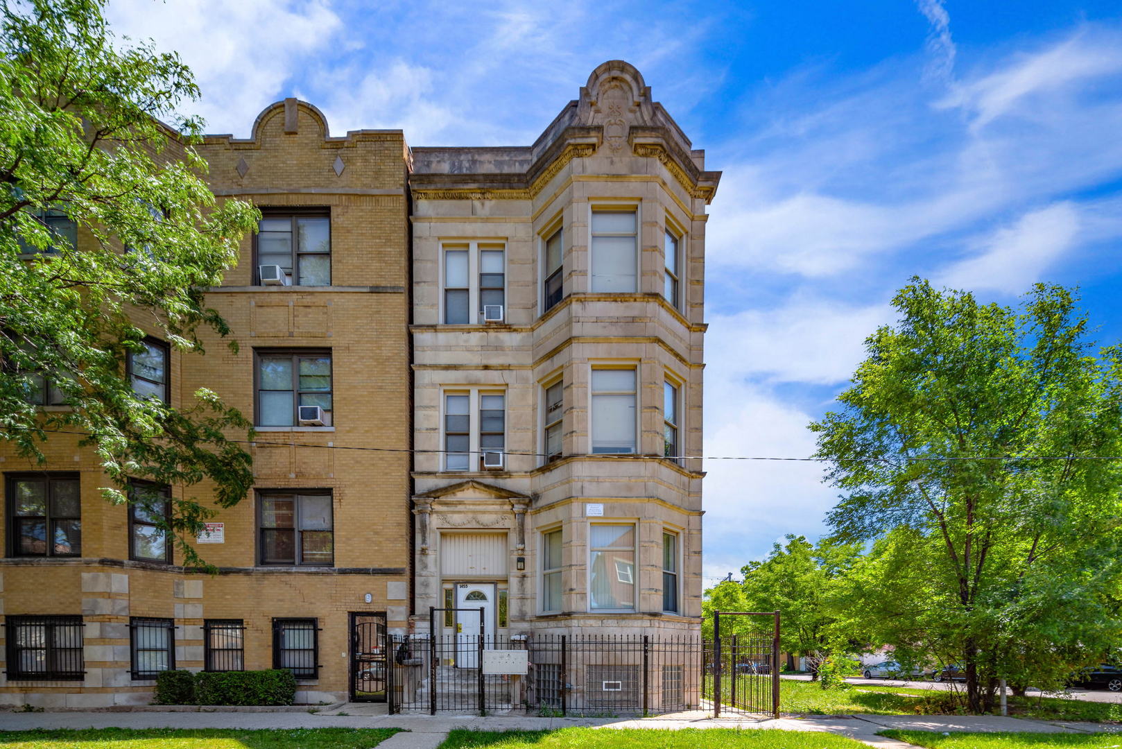 1455 South Avers Avenue Chicago, IL 60623 - Photo 2 of 22 a front view of a residential apartment building with a yard