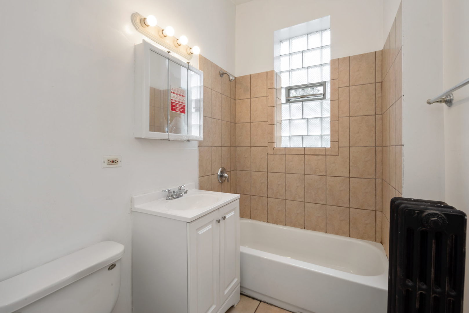 1455 South Avers Avenue Chicago, IL 60623 - Photo 6 of 22 a bathroom with a sink toilet vanity and bathtub