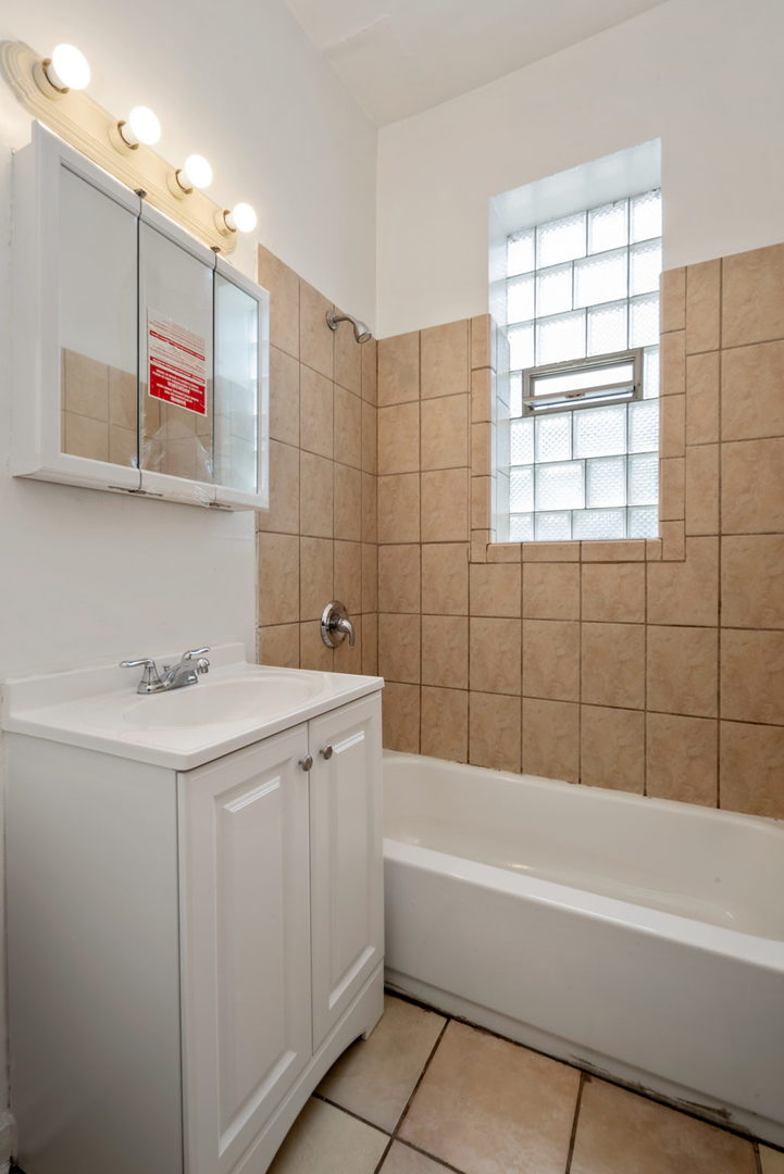 1455 South Avers Avenue Chicago, IL 60623 - Photo 7 of 22 a bathroom with a bathtub a sink and a shower