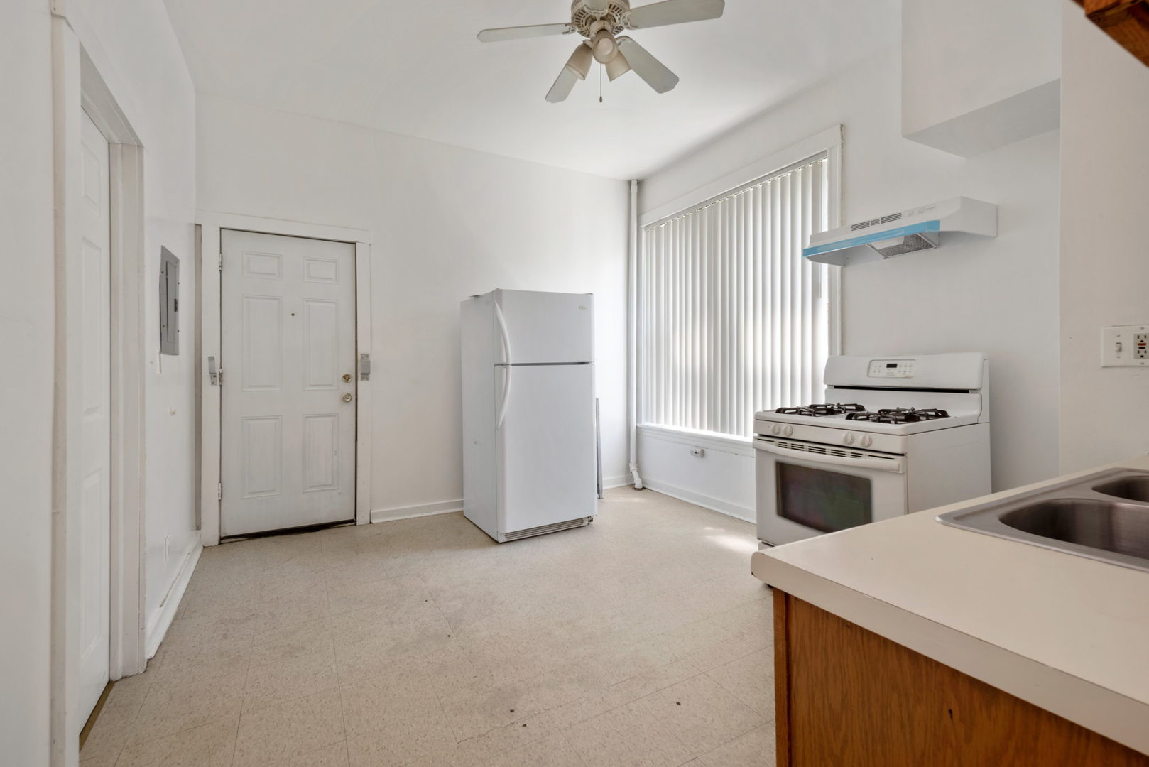 1455 South Avers Avenue Chicago, IL 60623 - Photo 10 of 22 a kitchen with cabinets and white appliances