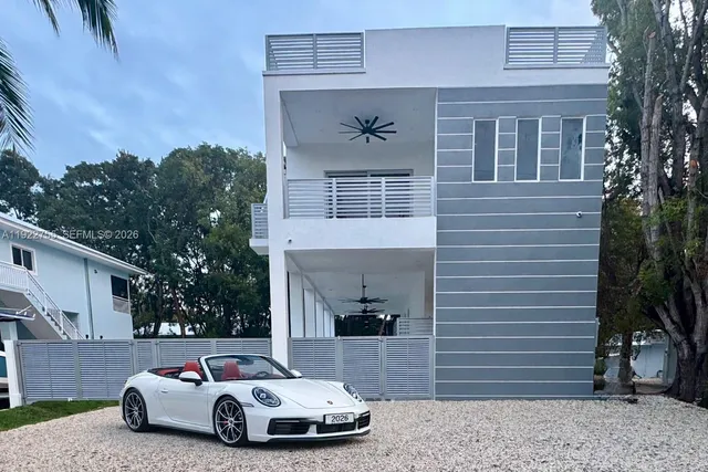 a car parked in front of a brick house