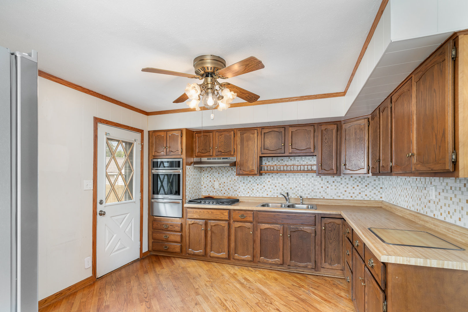 138 Cedar Circle Streamwood, IL 60107 - Photo 3 of 15 a kitchen with stainless steel appliances granite countertop a sink cabinets and wooden floor