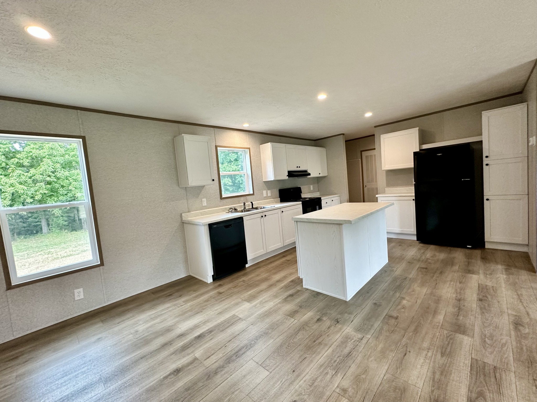 1667 Rabe Coats Road Westmoreland, TN 37186 - Photo 12 of 20 a large kitchen with stainless steel appliances kitchen island a large counter top and a wooden floors