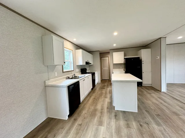a kitchen with a sink and refrigerator
