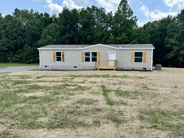 a house that has a tree in front of it
