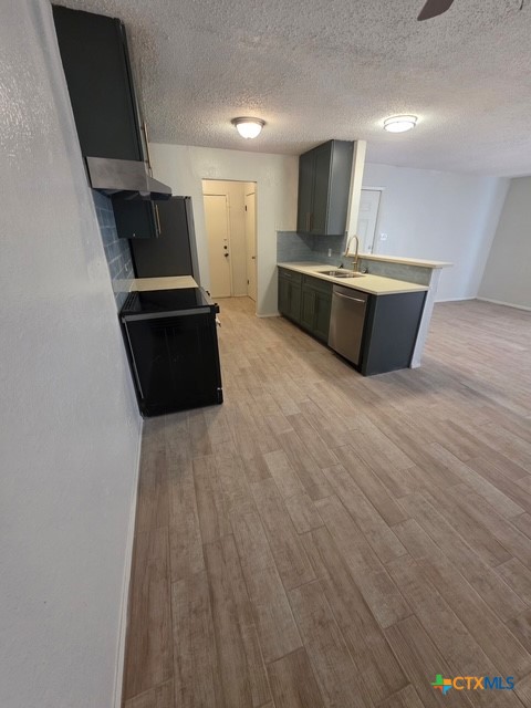 2010 South 15th Street, Unit B Temple, TX 76504 - Photo 4 of 12 a kitchen with stainless steel appliances a stove and a refrigerator
