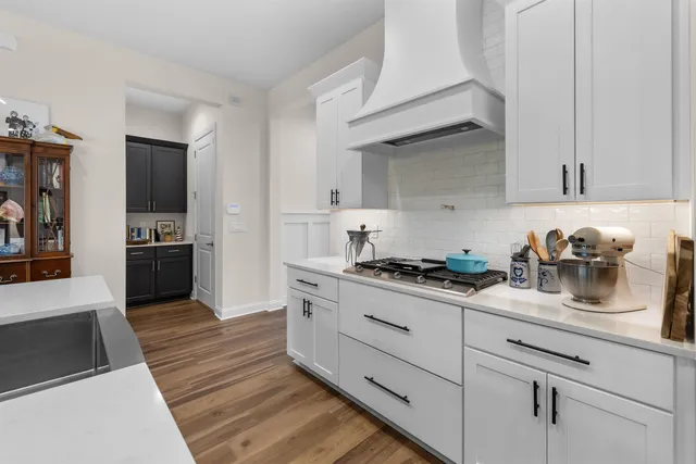 a kitchen with granite countertop cabinets and steel stainless steel appliances