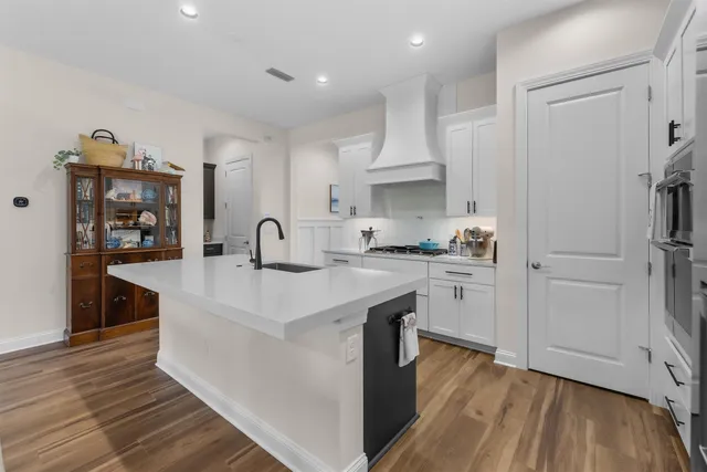 a kitchen with kitchen island a sink stainless steel appliances and cabinets