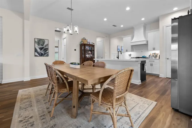 a dining area with stainless steel appliances kitchen island a dining table and chairs