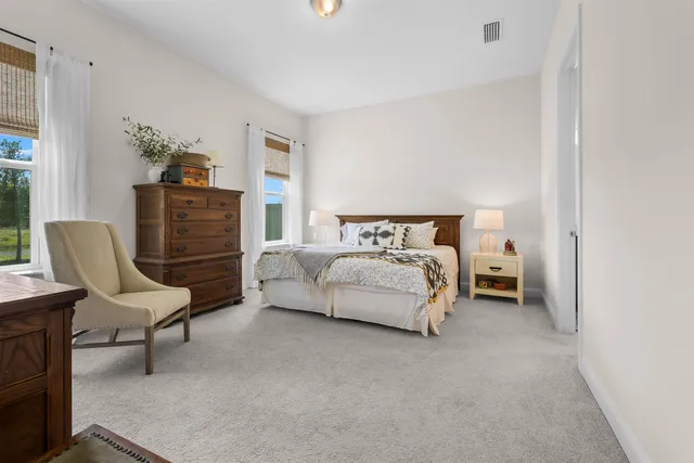 a bedroom with a bed and chair